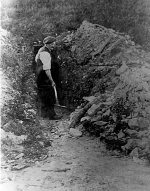 Photo of John Rookley outside his whetstone mine, early 1900s