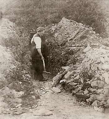 Photo of a miner outside his whetstone mine, early 1900s