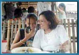 While at the beach, a young Ham enjoys ragchew using an ICOM-2GXAT while Mom looks on
