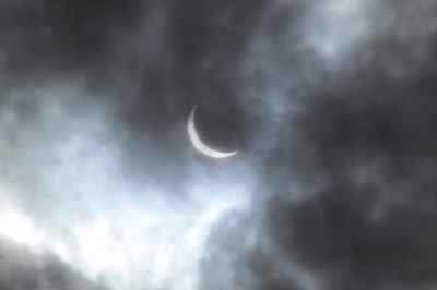Eclipse Through Clouds
