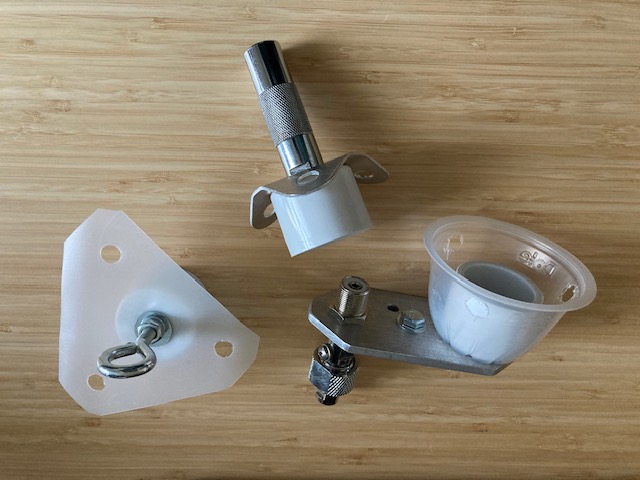 Photo of DIY 1" PVC mast tops, 1 eye hook, 1 3/8-24 to SO-239 mount, and 1 3/8-24 mount with guy holes.