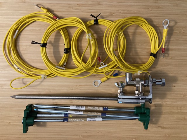Basic Vertical (BV) antenna components, mount with spike, stakes, 4 counterpoise wires (whip, coax are not shown).