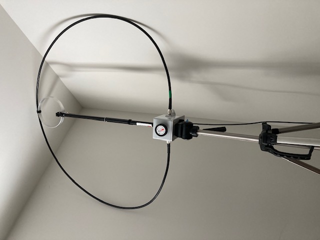 Indoor photo of Chameleon F-Loop 3 magnetic loop antenna on a camera tripod.