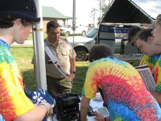 Dave, K4KDP, watches as the Scouts try their hand at code. 