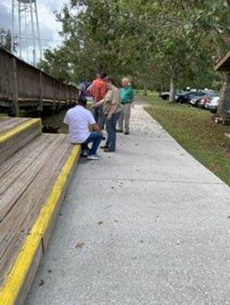 A group of people standing on a sidewalk

AI-generated content may be incorrect.