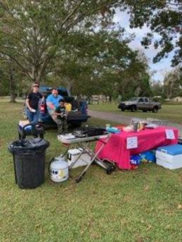 A group of people standing next to a table with food items

AI-generated content may be incorrect.