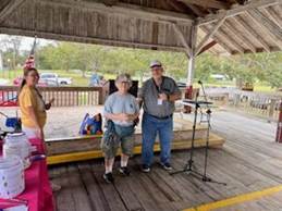 A group of people standing under a wooden deck

AI-generated content may be incorrect.