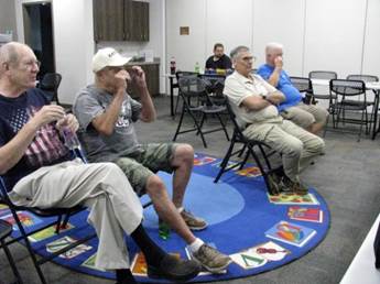 A group of men sitting in chairs

AI-generated content may be incorrect.