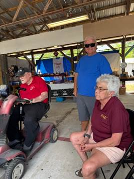 A group of people sitting outside

AI-generated content may be incorrect.