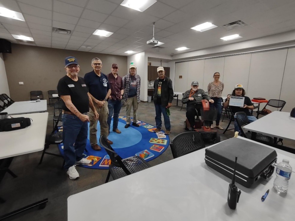 A group of men sitting at a table

Description automatically generated