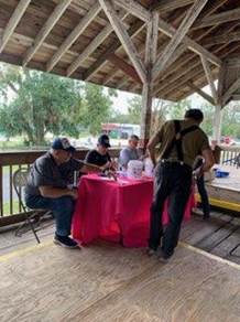 A person standing next to a table

Description automatically generated