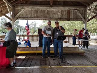 Two men sitting at a table looking at a computer