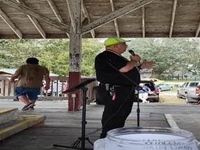 A person in a red hat sitting on a scooter

Description automatically generated