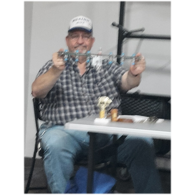 A person sitting at a table

Description automatically generated