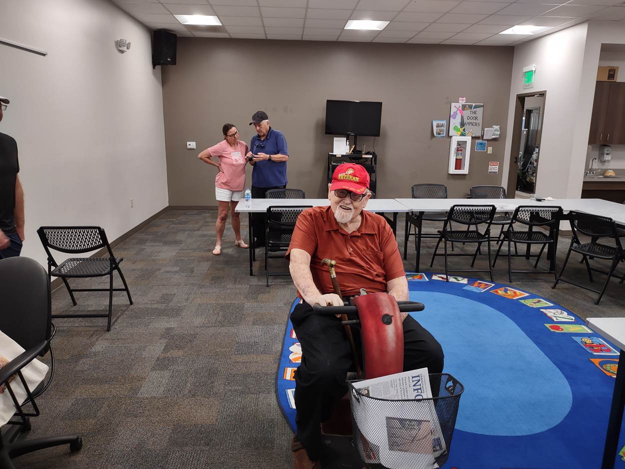 A person in a red shirt opening a box

Description automatically generated