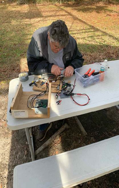 A person working on a table
Description automatically generated