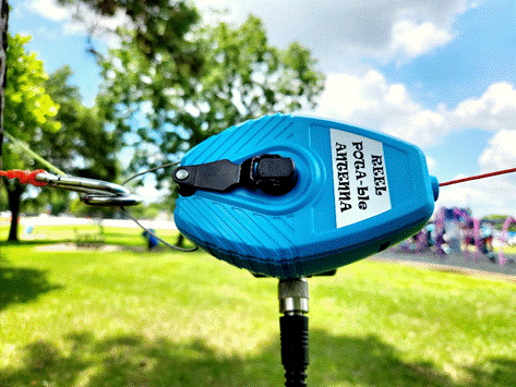 A blue tape measure on a wire

Description automatically generated